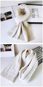 Detailed texture of thick cream white ribbed knit scarf with soft vertical stripe pattern
