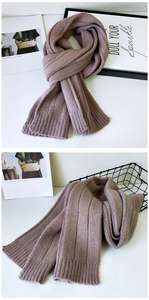 Detailed view of thick knit texture and ribbed pattern on dusty rose winter scarf
