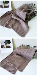 Detail of soft dusty pink knitted scarf showing rib-knit edges and thick wool texture