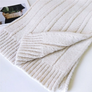 Thick white knit winter scarf featuring warm ribbed edges and soft textured patterns
