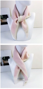 Detail of pink and beige knitted triangle scarf showing soft texture and knotting styles