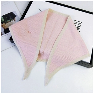 Detail of pink and beige knit scarf with cross-through hole for easy styling