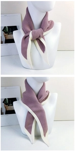 Detail view of purple knit scarf with cream white trim showing various tying styles