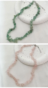 Detail of irregular natural stone necklaces in green aventurine and rose quartz crystals