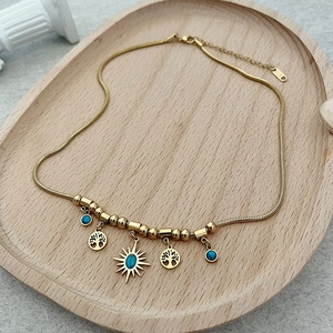 Collana a serpente dorata con ciondoli albero della vita e perline turchesi