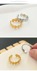 Detail of seashell fan design adjustable rings in gold and silver stainless steel