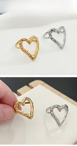 Detailed view of adjustable hammer texture open heart rings in gold and silver finish