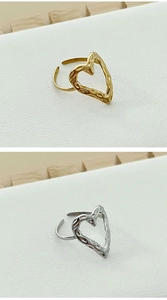 Detail of adjustable open rings with gold and silver hammered heart texture finish