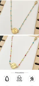 Detail of gold hollow Tai Chi pendants with colorful beads on delicate stainless chains