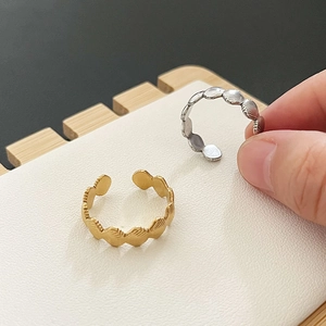 Shell shaped 18k gold and silver stainless steel open rings with radial texture