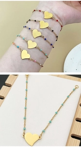 Detail of colorful beaded heart bracelets featuring gold charms in varied vibrant colors