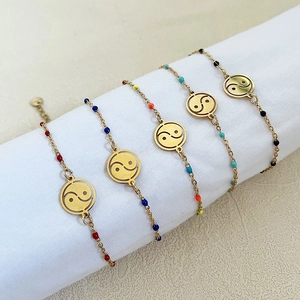 Set of five gold stainless steel bracelets with colorful beads and Yin Yang charm