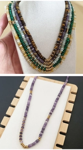 Close-up of handmade natural gemstone disk necklaces featuring malachite and tiger eye beads
