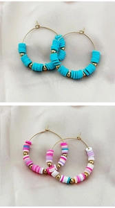 Detail of colorful Bohemian clay Heishi beads on gold-plated stainless steel hoop earrings