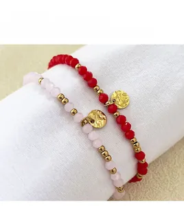 Detail of beaded bracelets with 18K gold-plated charms and colorful natural stones