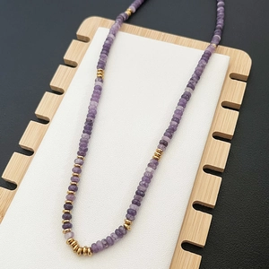 Handmade necklace with purple natural semi-precious stone discs and golden metal spacers