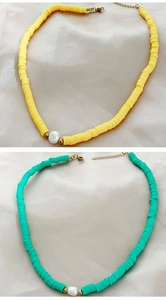 Detail of colorful heishi bead necklaces with freshwater pearls and gold lobster clasps