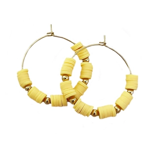 Bohemian gold hoop earrings with yellow heishi clay beads and metallic accents