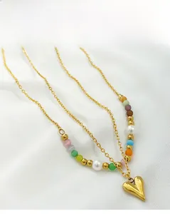 Close-up of heart charm necklace with colorful cat-eye beads and titanium steel chain