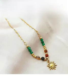 Detail of 18K gold stainless steel sun pendant necklace with vibrant multi-colored beads