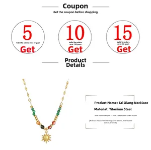 Detail of 18K gold stainless steel necklace with sun pendant and colorful beads