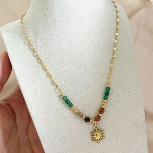 Bohemian gold leaf chain necklace with sun pendant and colorful beads on display