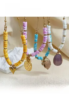 Détail de colliers bohèmes en perles d'argile colorées avec pendentifs coquillages naturels