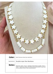 Detail of double-layer stainless steel necklace with shell stars and pearls on pink silk