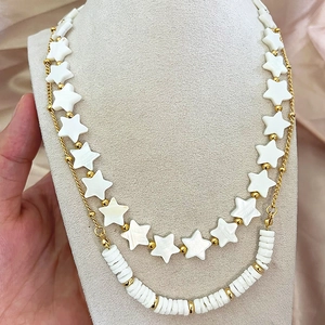 Double-layered vintage star beaded necklace with gold finish on jewelry bust