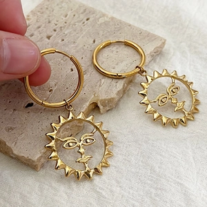 Artistic gold sun face hoop earrings in stainless steel with a vintage engraved design