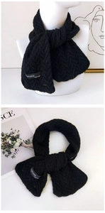 Détail de la texture en maille torsadée noire avec étiquette de marque et laine douce