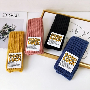 Good Luck knitted winter scarves for couples in mustard yellow, pink, blue, and black