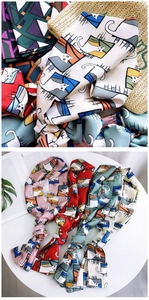 Detail of silk-feel skinny scarves featuring colorful cartoon cat window illustrations