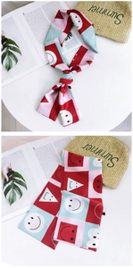 Detail of color-block satin skinny scarf with playful smiley patterns and geometric shapes