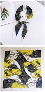 Detail of silk-feel square scarf with navy paisley pattern and gold buckle print