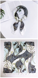 Detailed pattern of silk scarf with equestrian horse motifs and paisley floral design