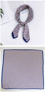 Detailed view of square silk scarf with red, blue and white geometric H-pattern