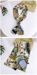 Detailed pattern view of a long silk scarf featuring classical European motifs and soft edges