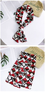 Close-up of narrow geometric print twilly scarf with elegant knotting and silk-like texture