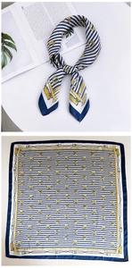 Detail of navy blue nautical square silk scarf with golden chain and tassel patterns