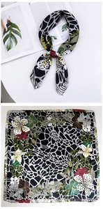 Detail of floral and leopard print silk scarf with tropical hibiscus and palm leaves