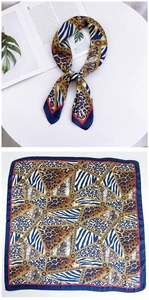 Detail of square silk scarf with animal print, leopard patterns and gold chain details