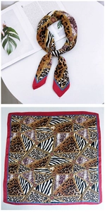 Detail of elegant animal print silk scarf with mixed leopard and zebra patterns in red borders