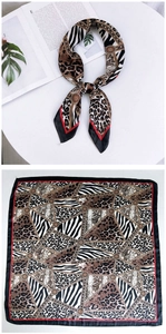 Close-up of retro animal print silk scarf with leopard and zebra patterns and geometric details