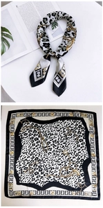 Detail of square silk scarf with leopard print, golden chains and geometric borders
