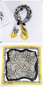Detail of square silk scarf featuring leopard print, golden chains and geometric patterns