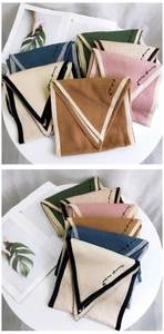 Detail of colorful knit scarves with contrast trim and Thank You My Love heart embroidery