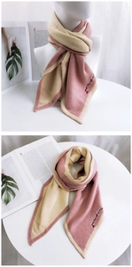 Detail of beige and pink knitted scarf with Thank You My Love embroidery and heart