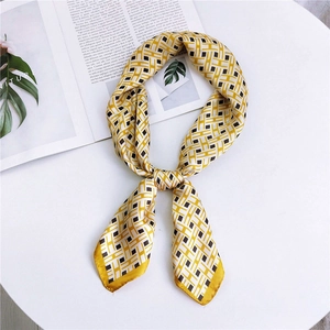 Elegant yellow square silk scarf with geometric H-pattern on a minimalist white stand