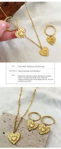Detail view of heart necklace and earrings set with sunray pattern in gold-plated steel